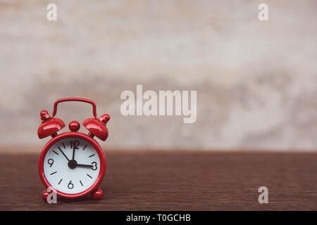 Red alarm clock on table dark plank wooden background with copy space Stock Photo