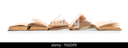 Old open books row. Isolated on white, clipping path included Stock Photo