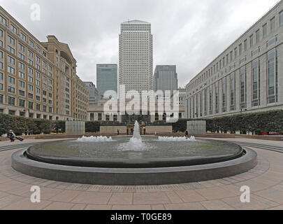 London, United Kingdom - October 15, 2010: Cabot Square Fountain and Tall Skyscraper Buildings at Canary Wharf in London, UK. Stock Photo