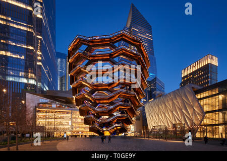 The Vessel, also known as the Hudson Yards Staircase (designed by architect Thomas Heatherwick) at dusk. On the right, The Shed. Manhattan, New York Stock Photo