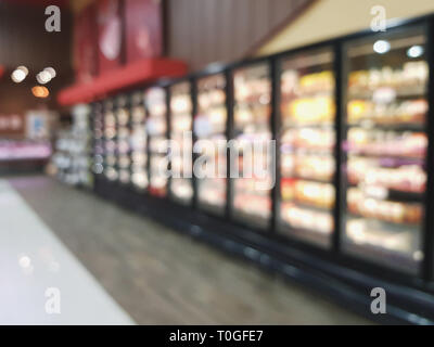 Row of refrigerators racks in hypermarket blurred background Stock Photo