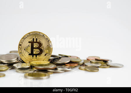 Golden bitcoin over many international money coins isolated on white background.  Crypto currency concept.  Bitcoin cryptocurrency background concept  Stock Photo