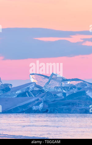 blue toros of Baikal against the background of the pink sky of the dawn and purple clouds Stock Photo