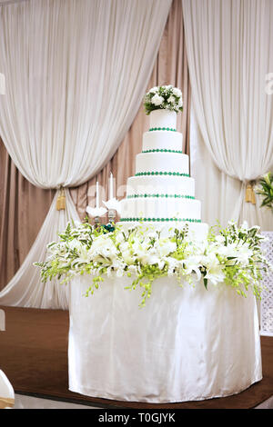 a big mock up layer cake used to be the base for real cake in wedding party Stock Photo