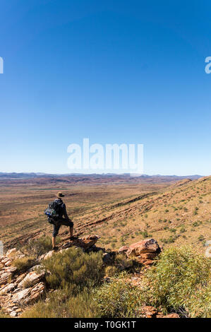 Hiker at the top of Mount Gillen just outside Alice Springs in central Australia. Stock Photo