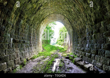Long underground brick tunnel Stock Photo