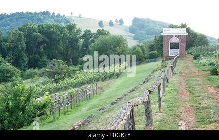 Thomas Jefferson's Monticello experimental vegetable and flower garden with long view of the terrace and gazebo / pavilion and neighboring mountain. Stock Photo