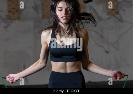 Cute little girl in sportswear doing fitness exercises at home. Distant  training with personal trainer, social distance or self-isolation, online  Stock Photo - Alamy