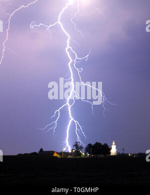 Lightning bolt at strom over village Stock Photo
