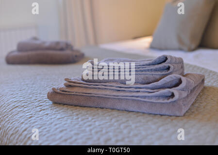towels folded on a guest bed Stock Photo