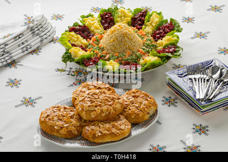Dish with traditional festive Moroccan mixed salad and mini bastella on a nice set table Stock Photo