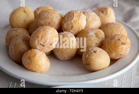 Portion of Canarian wrinkly potatoes on a white plate Stock Photo