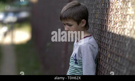 lonely boy, pain on face, regret for action Stock Photo