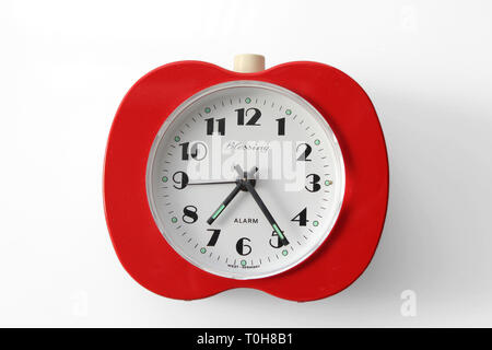 Vintage alarm clock apple inspired, isolated on white background, close-up Stock Photo