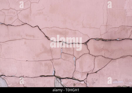 painted weathered cracked textured pink wall. background, exterior Stock Photo