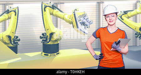 A young female technician while machine constructing in a manufacturing plant Stock Photo