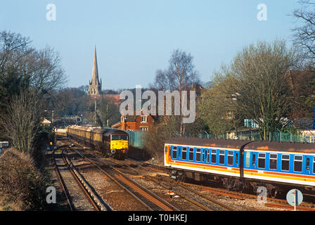 A class 47 diesel locomotive number 47799 working a Venice Simplon Orient Express excursion passing a SouthWest Trains class 411 4CEP electric multiple unit at Wokingham. 23rd March 2003. Stock Photo