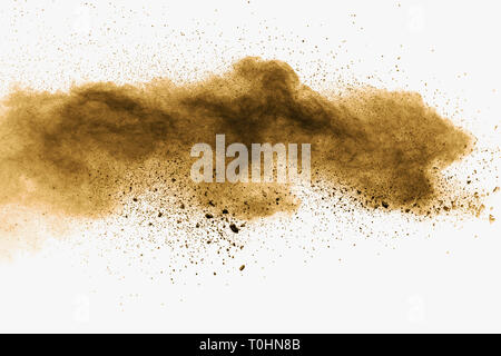 Abstract deep brown dust explosion on white background.  Freeze motion of coffee liked color dust splash. Stock Photo