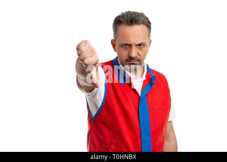 Male supermarket or hypermarket employee making dislike gesture as thumbs down with angry expression isolated on white studio background Stock Photo