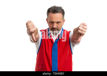 Angry hypermarket or supermarket male employee holding double thumbs down as dislike gesture isolated on white studio background Stock Photo