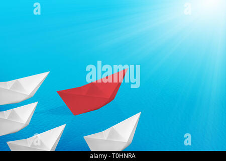 Red paper boats lead the white paper boats on the sea. Leadership concept Stock Photo