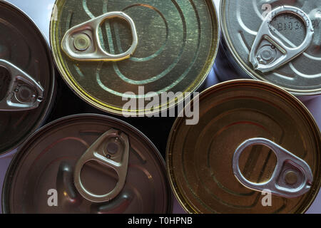 Close-up of a group of tin cans of food packaging in aluminum box with tongue to open Stock Photo