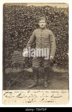 Original WW1 postcard portrait of German soldier, Heinrich - wearing infantry soldier uniform, boots, field cap (kratzchen) Postcard sent from Cassel, France to brother, Willy, in Verdun, N.E. France,  dated / posted 13 Jan 1915 Stock Photo