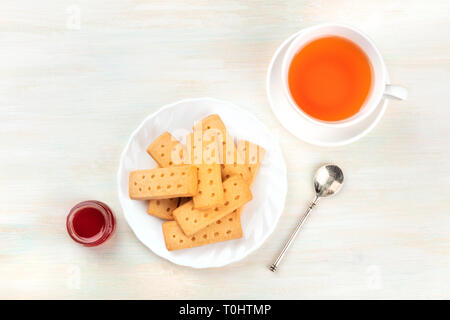 Scottish shortbread butter cookies, shot from the top with a cup of tea, a jar of jam, and copy space Stock Photo