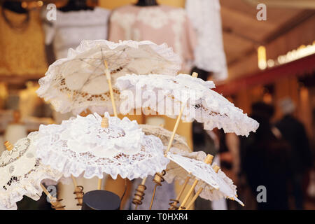White lace umbrellas on the island of Burano, shop with lace, Venice, Italy Stock Photo