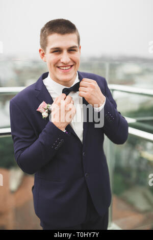 Headshot portrait of young man smiling isolated on outside outdoors background. Stock Photo