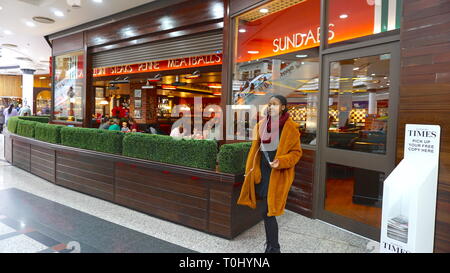 Young lady out shopping in Harrow, London, United Kingdom Stock Photo