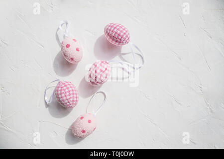 Top view of easter eggs colored with pink paint in differen patterns. Various striped and dotted designs. White background. Copy space.Egg design Stock Photo