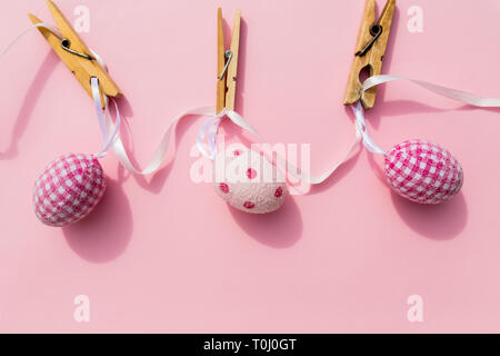 Three colorful easter eggs isolated on pink backgrund.set of Easter eggs.Hand made collection of Easter eggs lying on the surface with different Stock Photo