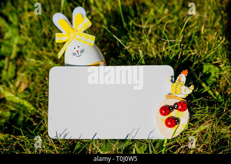 Bunny shaped easter eggs.Happy Easter pattern. Stylish easter eggs on meadow background. Modern easter eggs painted with natural dye in dye in green Stock Photo