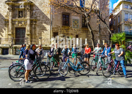 Valencia tourists Group of women on rental bike Valencia Old Town Spain bicycle city Bicycles in Valencia group cyclists city Stock Photo