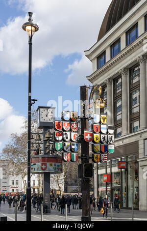 LONDON, UK - MARCH 11 : Coats of Arms and clock at the entrance to Leicester Square in London on March 11, 2019. Unidentified people Stock Photo