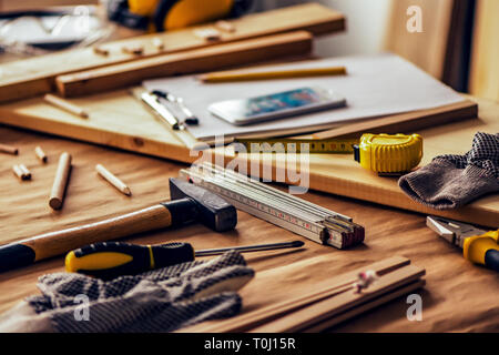 Various tools on carpentry woodwork workshop desk, selective focus with shallow depth of field Stock Photo