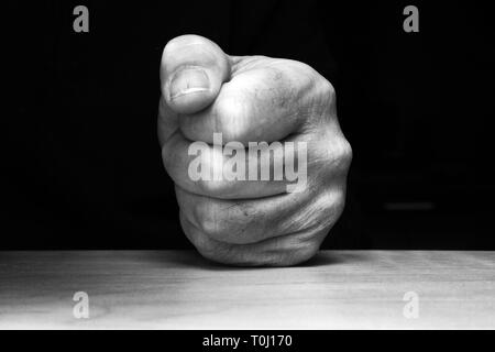 Fist pounding on a table Stock Photo