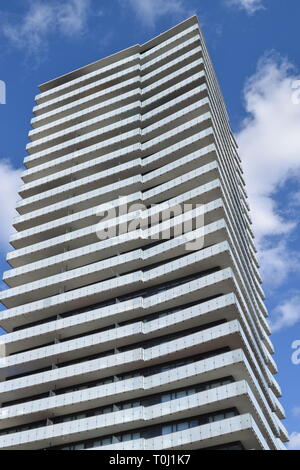Side View Of New Condo Tower, Symmetrical With Lots of Glass. Light Cloudy Blue Sky In The Background. Toronto Ontario Canada. Stock Photo