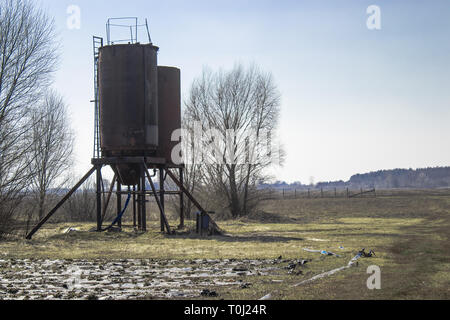 Iron towers for water on the field. Water storage tanks. Water storage in agriculture. Stock Photo