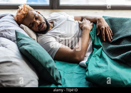 Nice peaceful young man seeing pleasant dreams Stock Photo