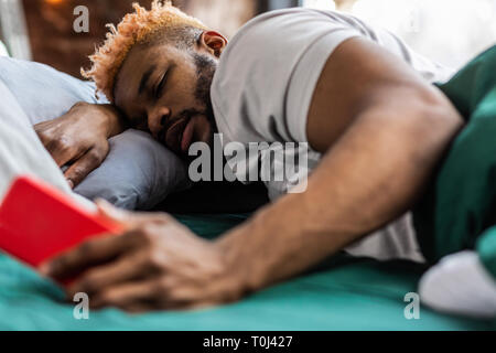 Good looking nice man holding his smartphone in the hands Stock Photo