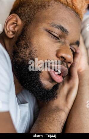 Nice sleepy man having very pleasant dreams Stock Photo