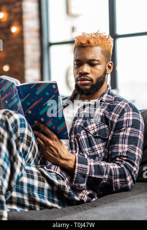 Nice smart man getting new knowledge from the book Stock Photo