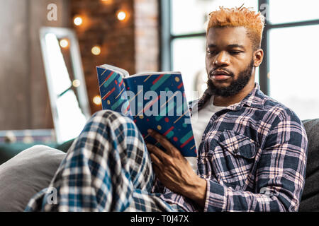 Nice good looking man enjoying reading a book Stock Photo