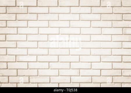 Cream and white brick wall texture background. Brickwork or stonework flooring interior rock old pattern clean concrete grid uneven bricks design stac Stock Photo