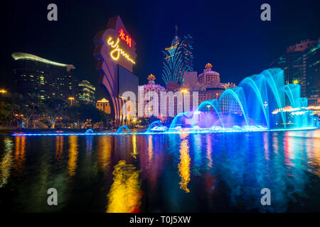 Beautiful and very colorful city with lots of bright neon signs. Photo of the dancing fountain show at the famous Wynn hotel. Stock Photo