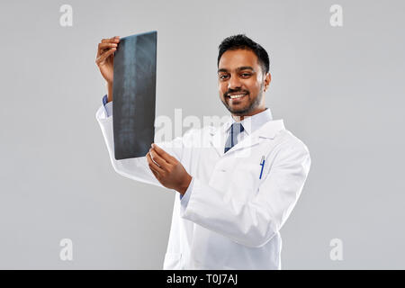 smiling indian doctor looking at spine x-ray Stock Photo