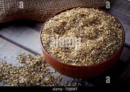 Za'atar (zatar), Middle Eastern spice mixture in wooden bowl Stock Photo