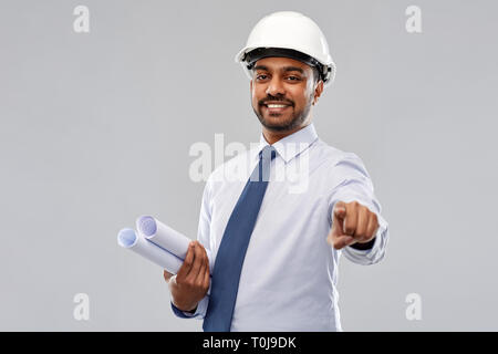 indian architect with blueprints pointing to you Stock Photo
